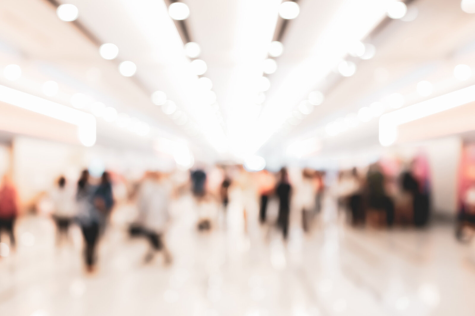 People walking around at a trade fair, blurred