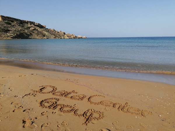 Sandy beach in Malta, where Data Center Group is written in the sand